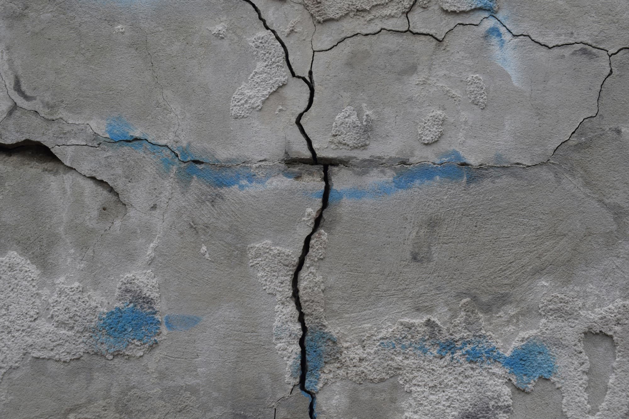 A structural crack running through a concrete foundation wall